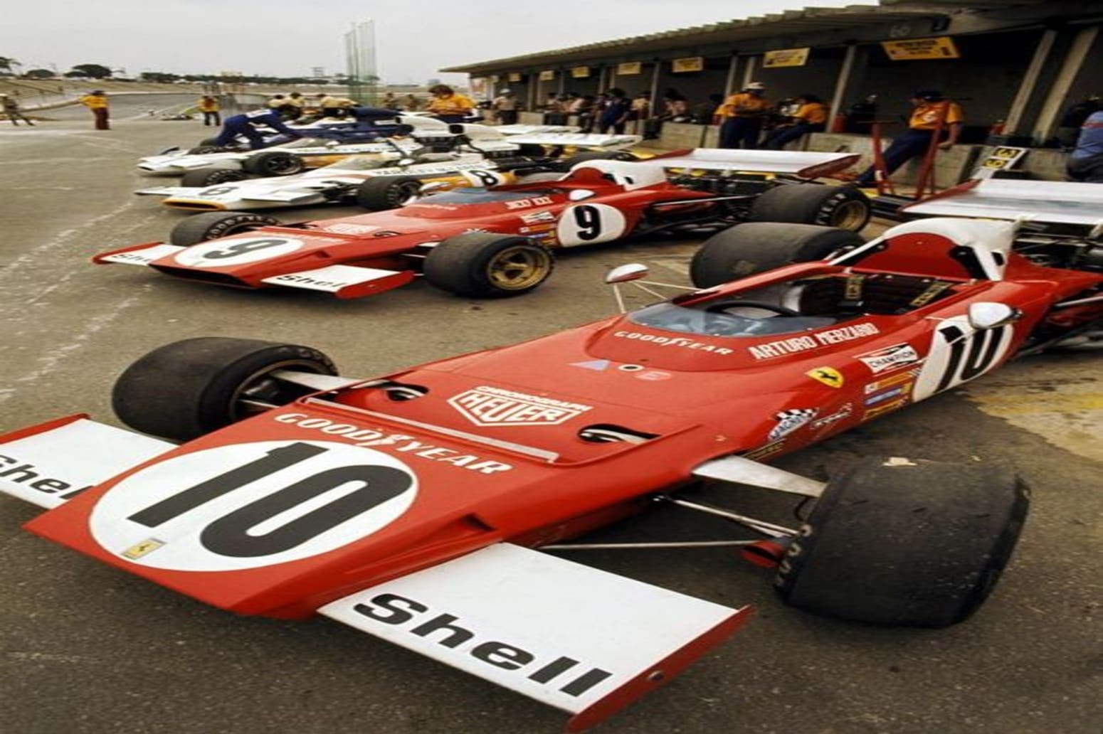a group of race cars parked on a track