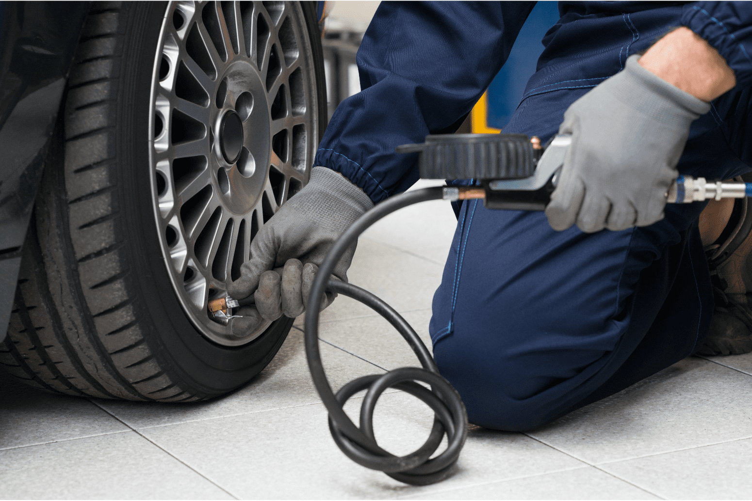 a person in gloves using a tire pump